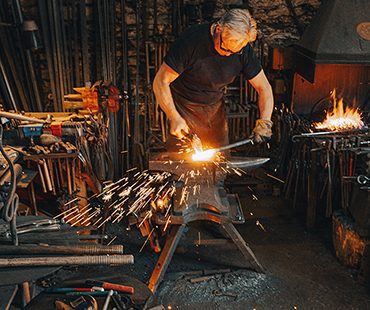 skilled iron worker welding custom furniture